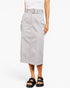 A model wearing a light gray mid-length utility skirt with a matching belt, styled with a white top and black slide sandals against a plain white background.