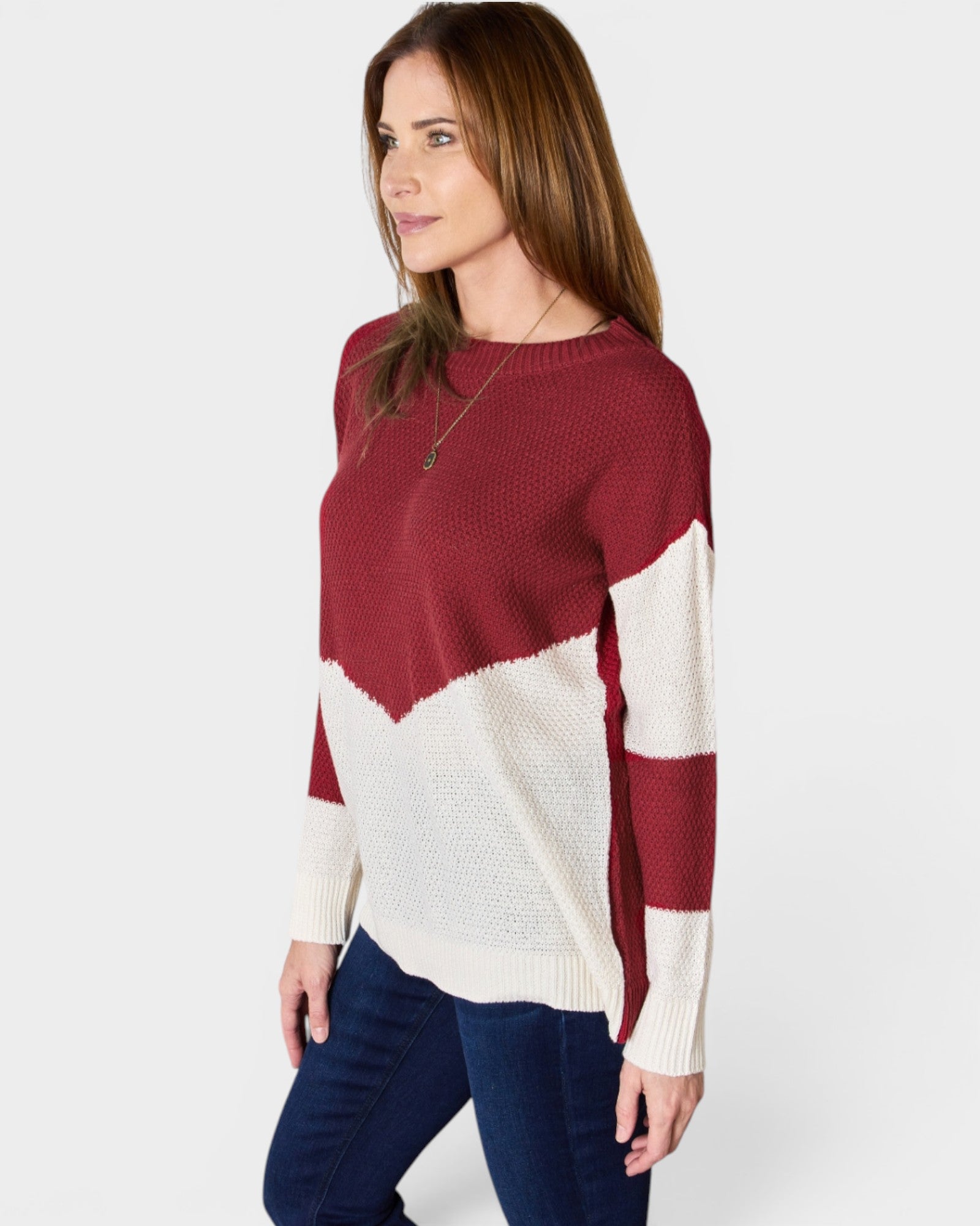 Woman wearing a red and white sweater on a white background