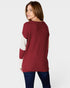 Woman wearing a red sweater with white sleeves on a white background