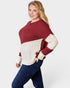 Woman wearing a red and white sweater with blue pants on a white background