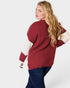 Woman wearing a red and white sweater on a white background
