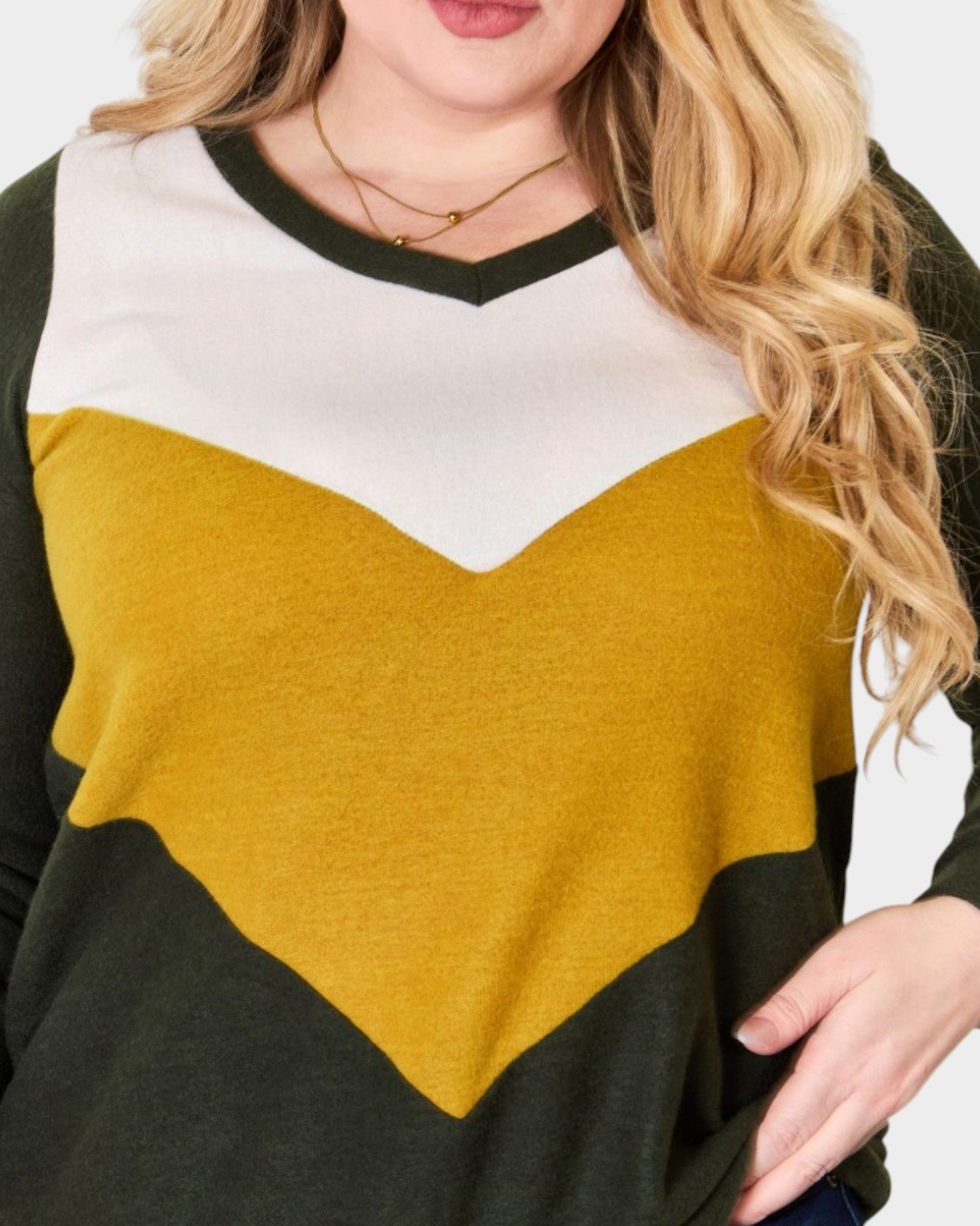 Color-blocked sweater with black, white, and mustard yellow sections.