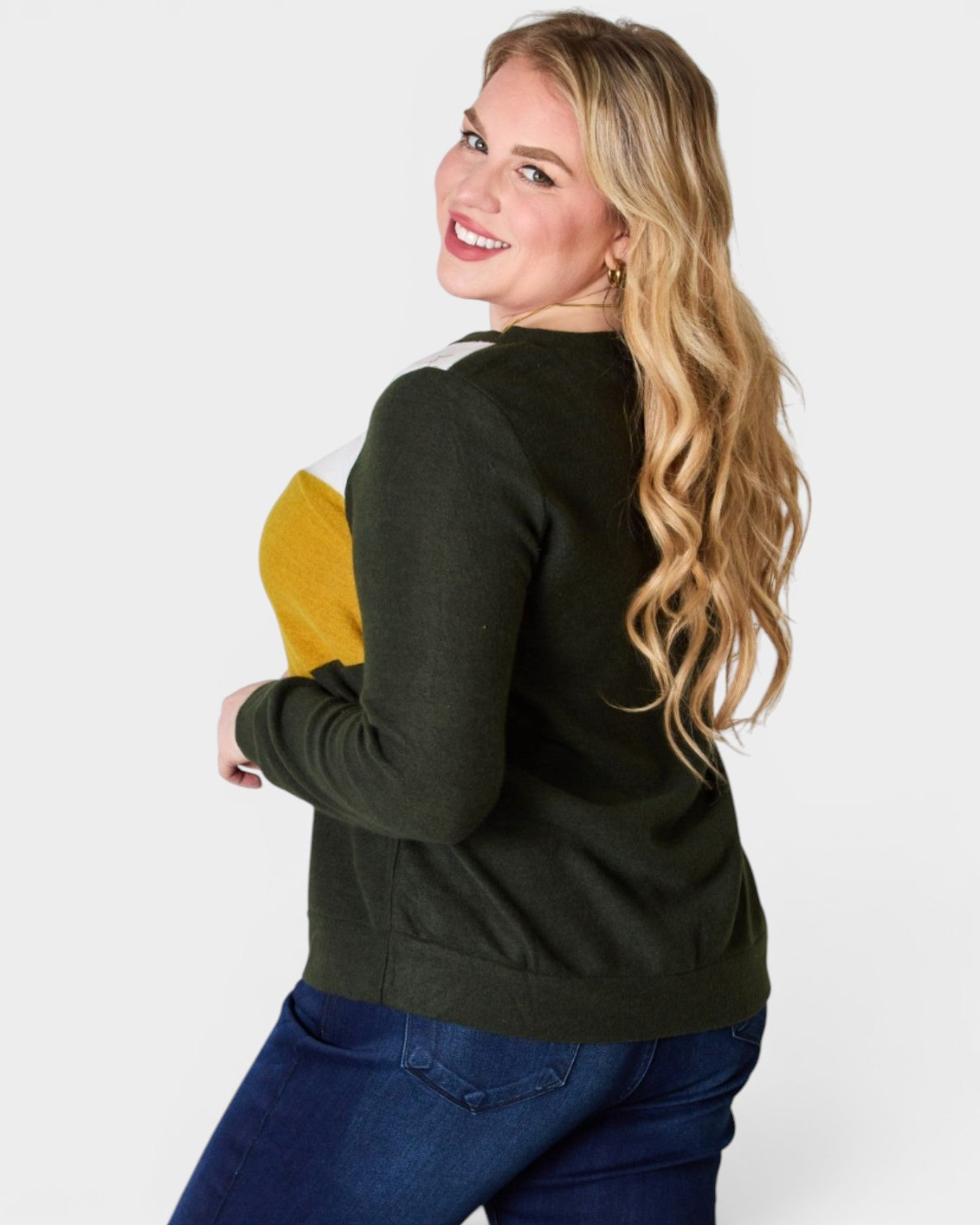 Woman wearing a black jacket with a yellow item in her arm on a white background
