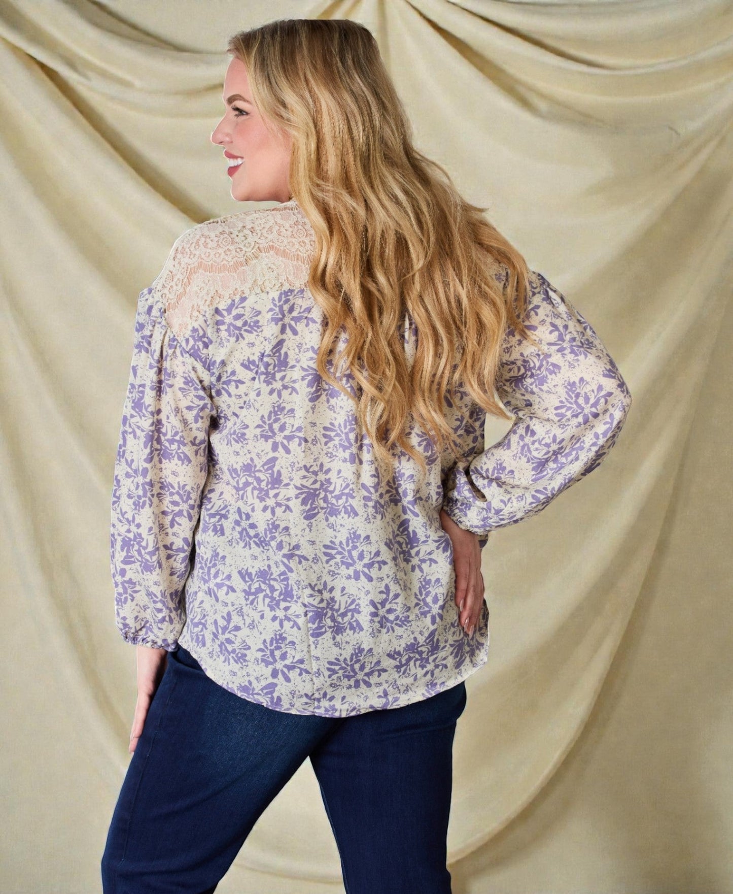 Woman wearing a floral blouse with a plain background