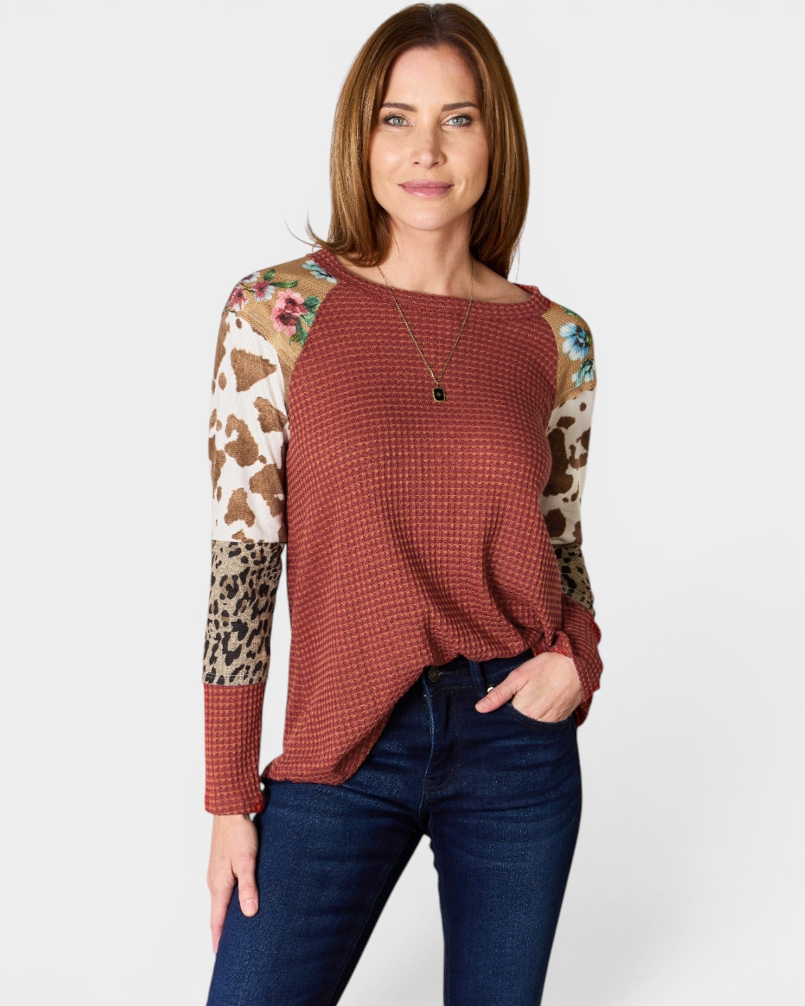Woman wearing a red checkered shirt with patterned sleeves on a white background