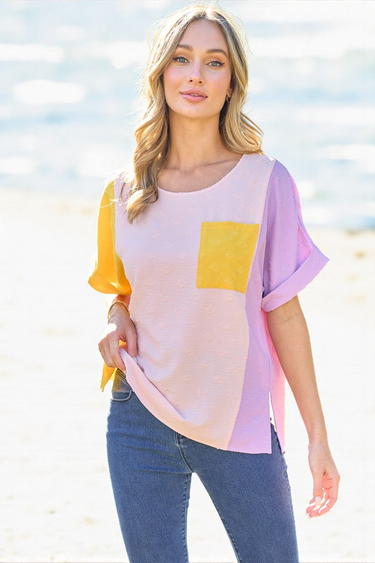 Woman wearing a colorful top with a blurred beach background