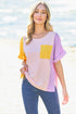 Woman wearing a colorful top with a blurred beach background