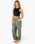 A woman modeling a pair of olive green wide-leg cargo pants with a black sleeveless crop top and beige flat sandals, standing against a plain white studio background.