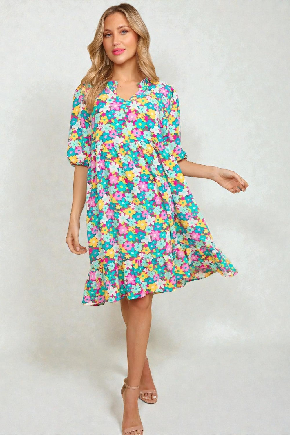 Woman wearing a colorful floral dress on a white background