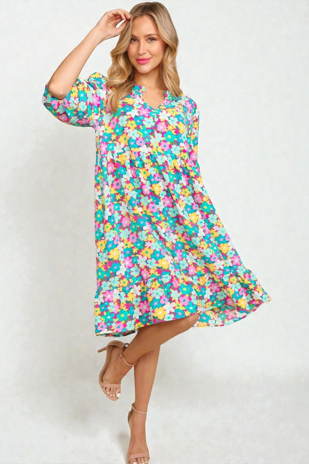 Woman wearing a colorful floral dress on a white background