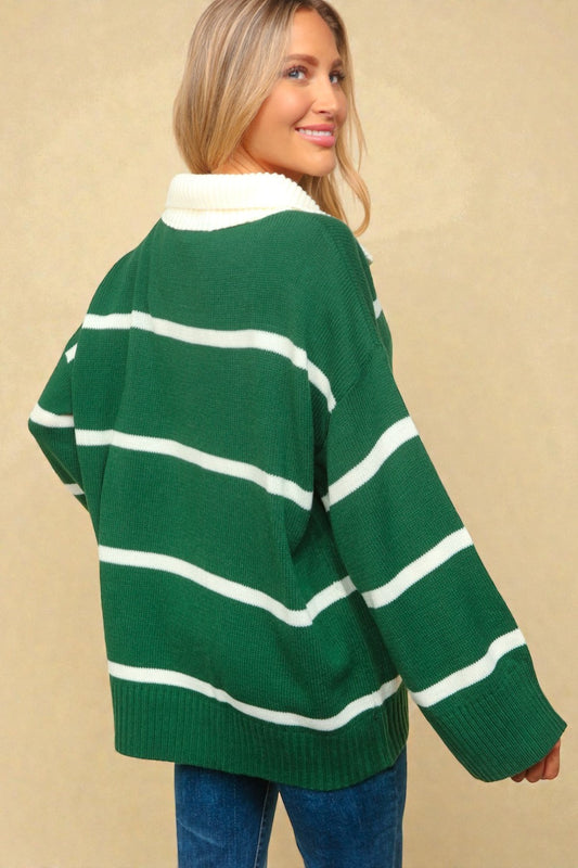 Woman wearing a green and white striped sweater against a beige background