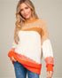 Woman wearing a colorful sweater with a neutral background