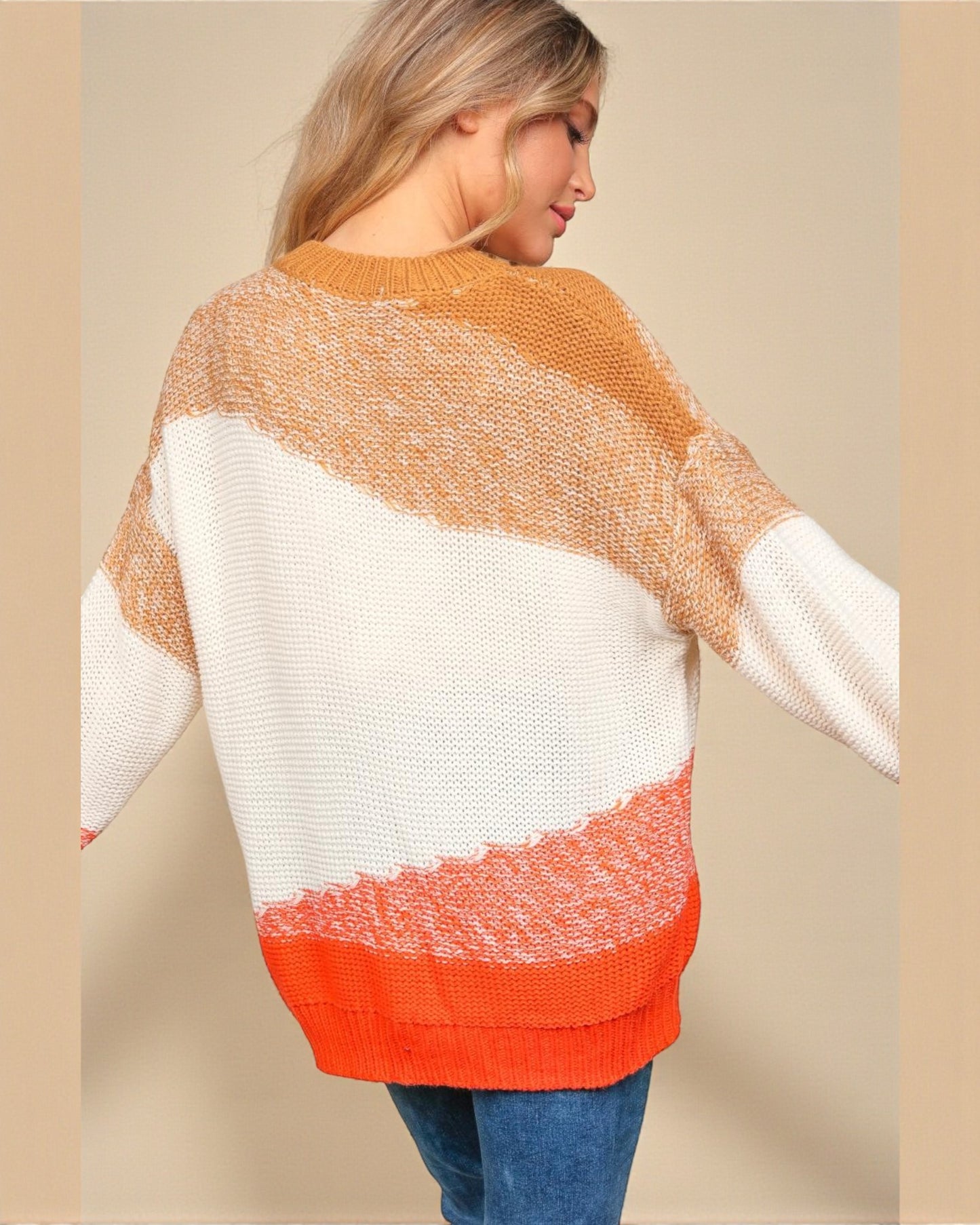 Woman wearing a colorful sweater with a neutral background