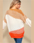 Woman wearing a colorful sweater with a neutral background