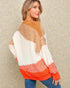 Woman wearing a colorful sweater with a patterned background
