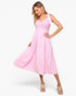 A woman modeling a light pink sleeveless midi dress with a lace bodice and tiered skirt, paired with beige platform sandals, against a plain white background.