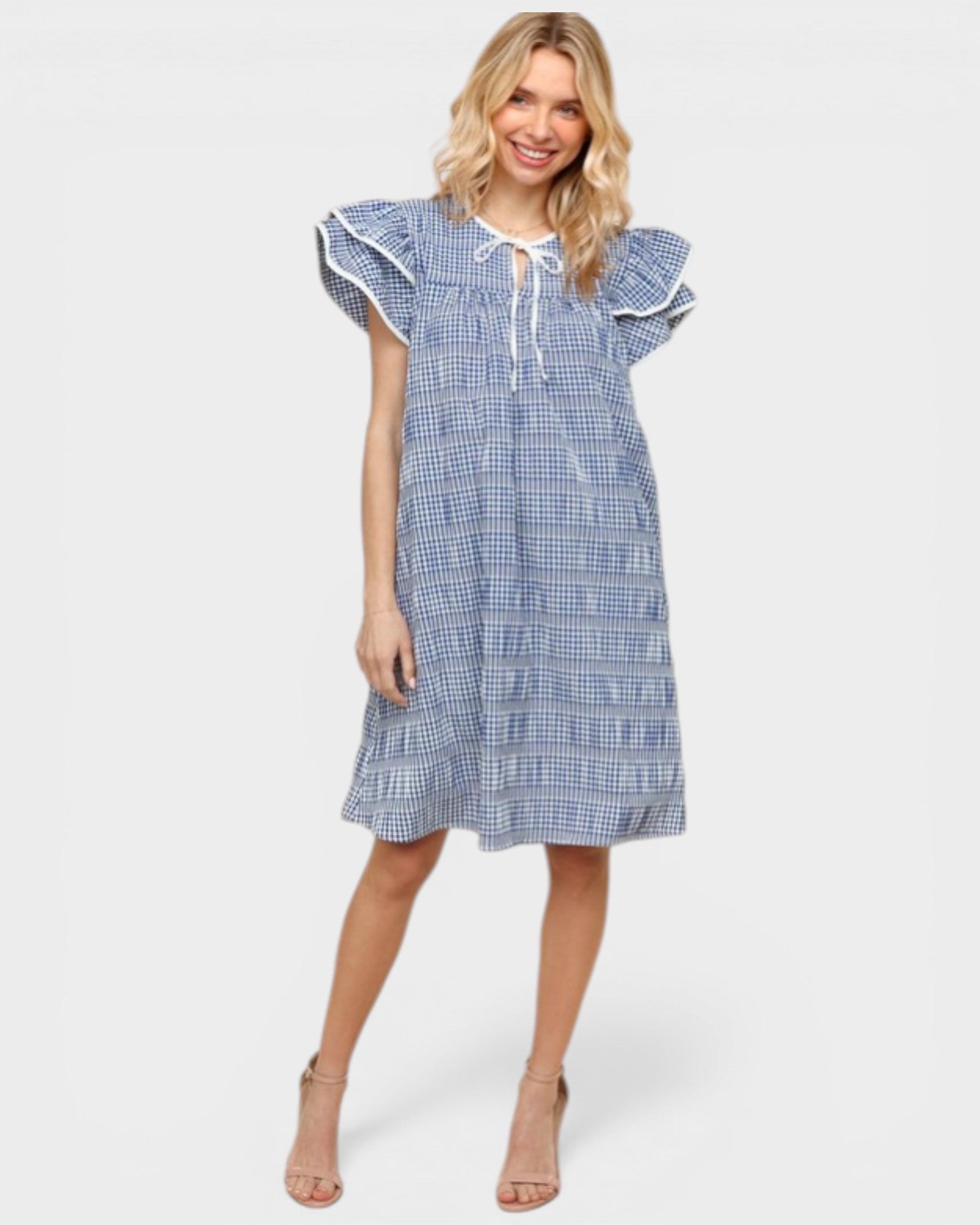 Woman wearing a blue checkered dress on a white background