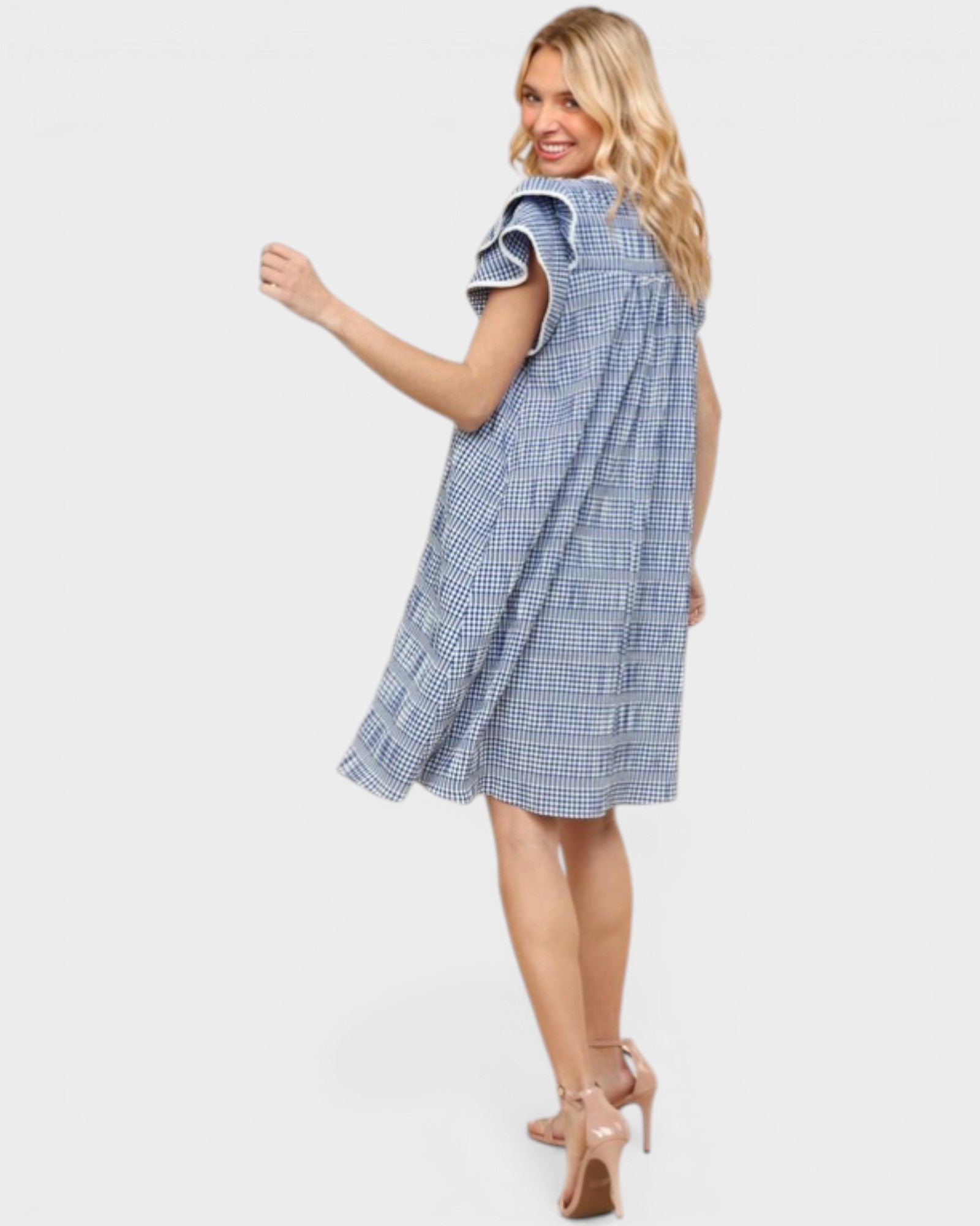 Woman wearing a blue checkered dress on a white background