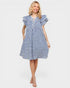 Woman wearing a blue checkered dress on a white background