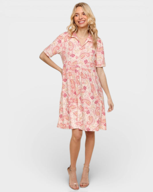 Woman wearing a pink floral dress on a white background