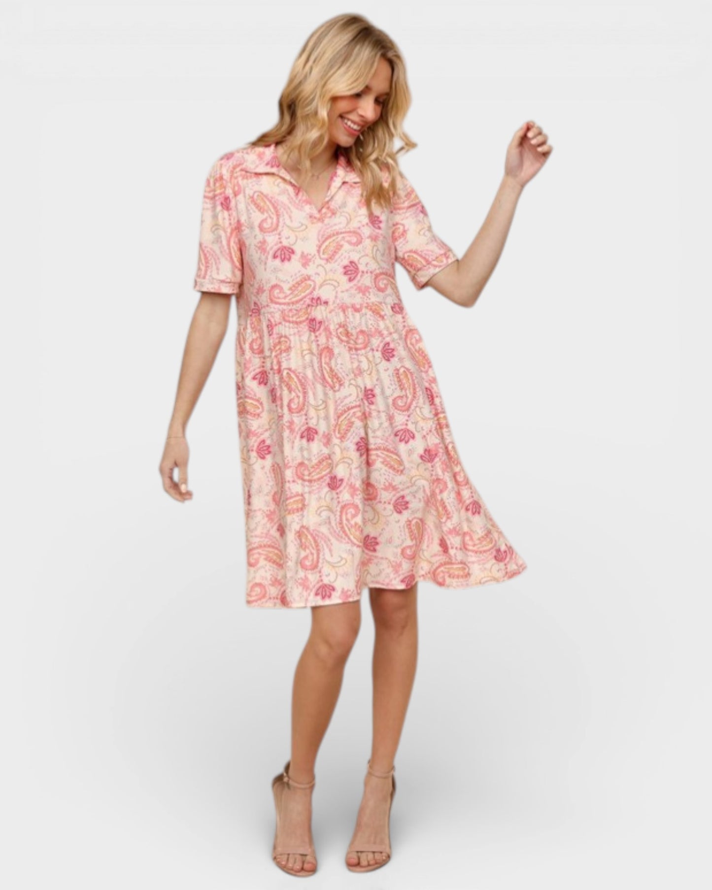 Woman wearing a pink floral dress on a white background