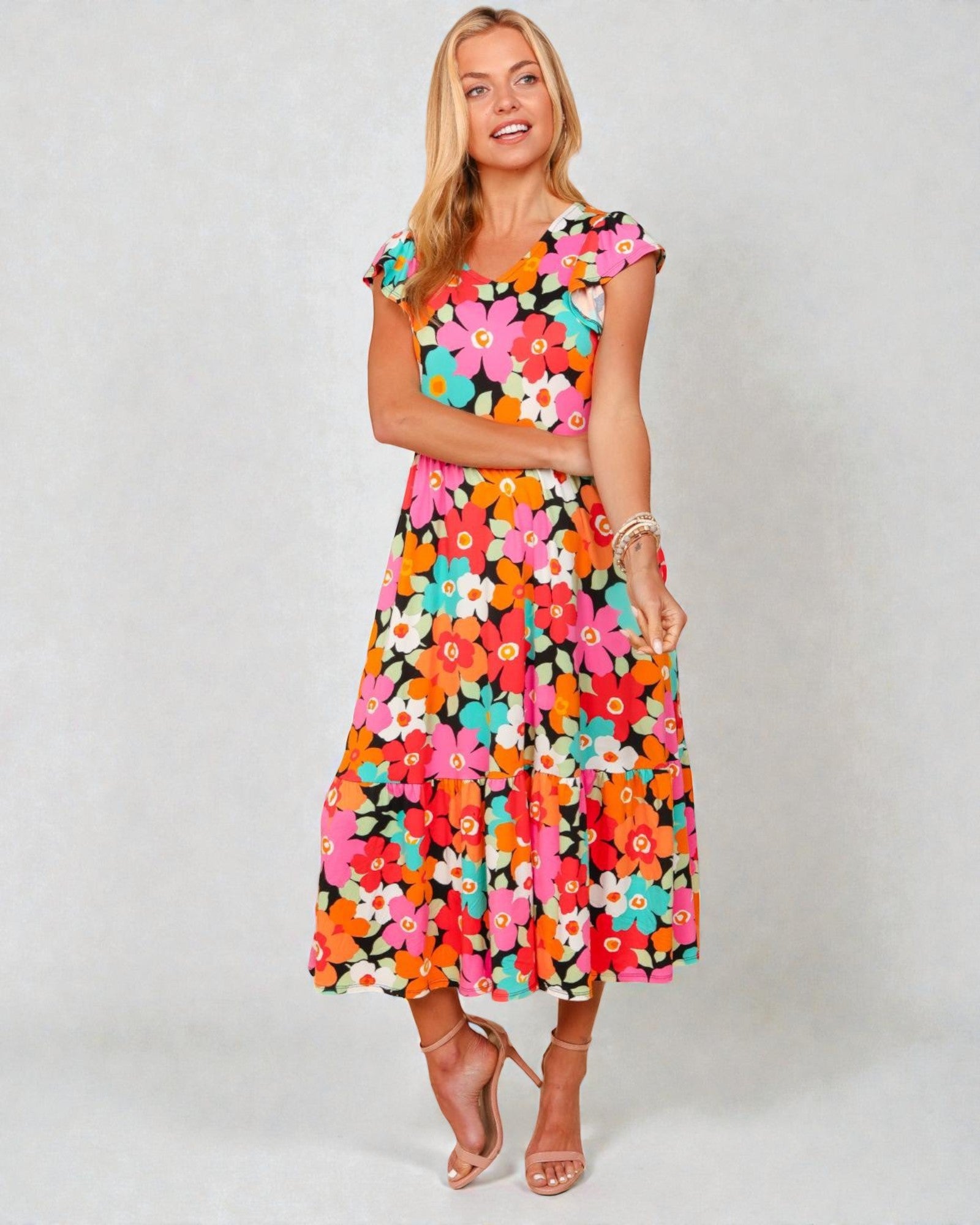 Woman wearing a colorful floral dress on a white background