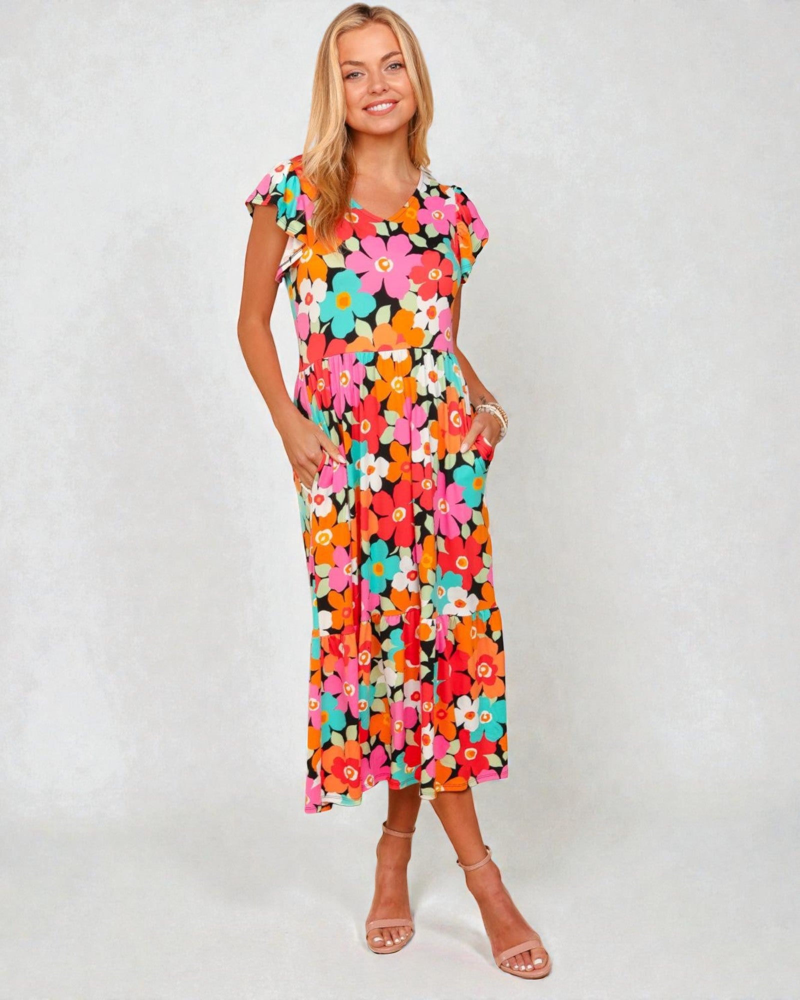 Woman wearing a colorful floral dress on a white background