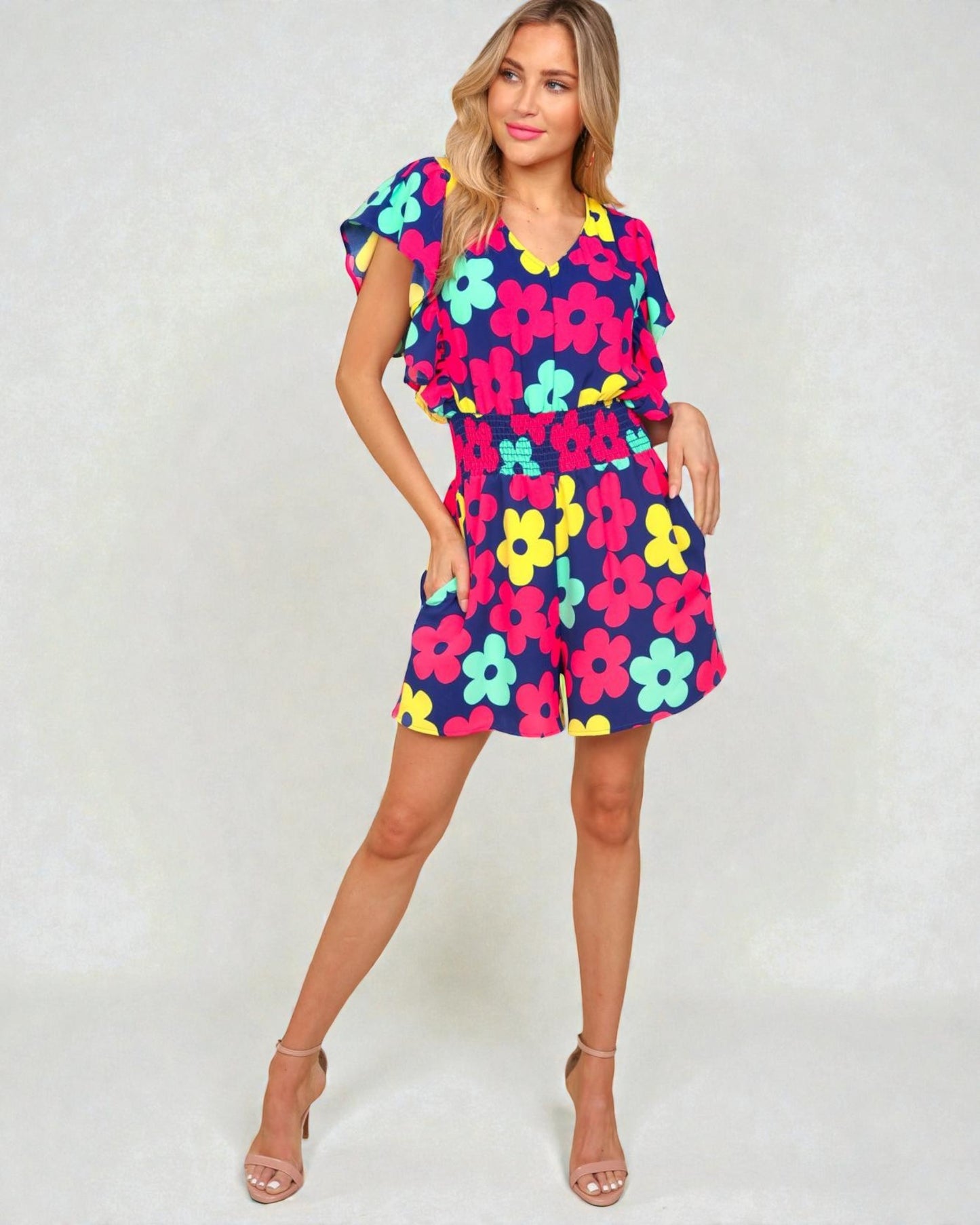 Woman wearing a colorful floral dress on a white background