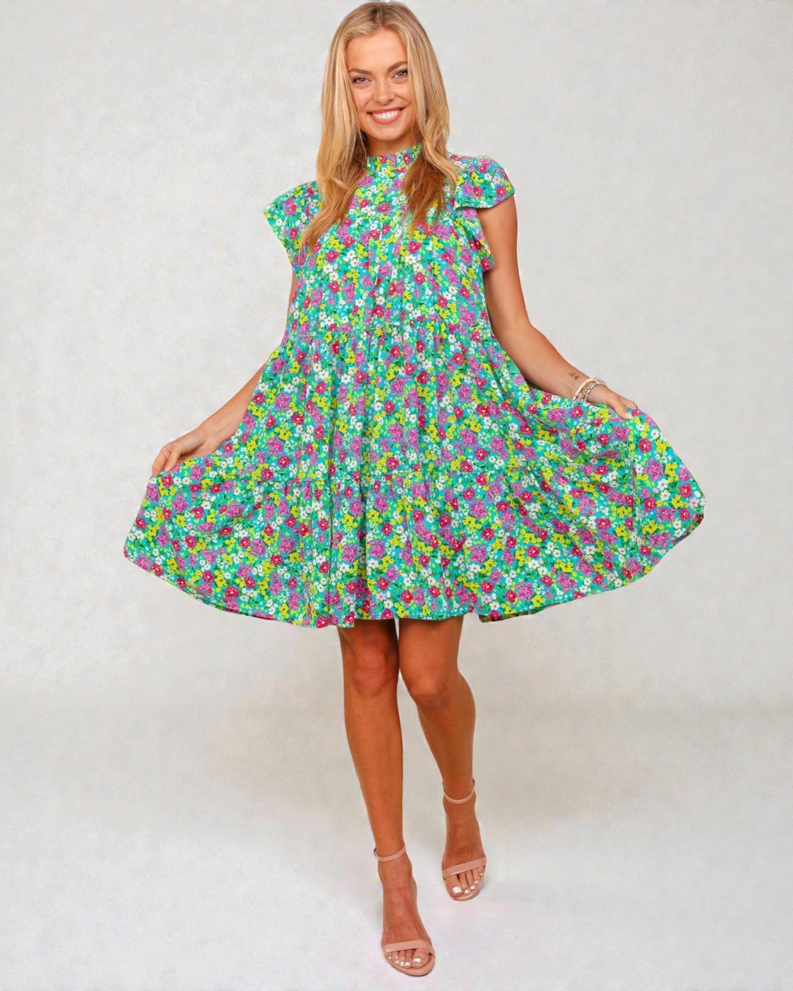 Woman wearing a colorful floral dress on a white background