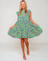 Woman wearing a colorful floral dress on a white background