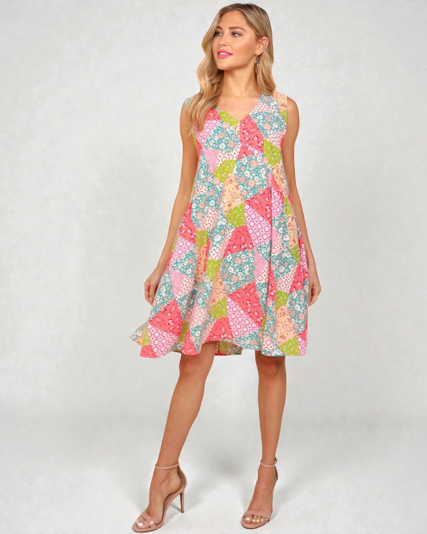 Woman wearing a colorful patterned dress on a white background