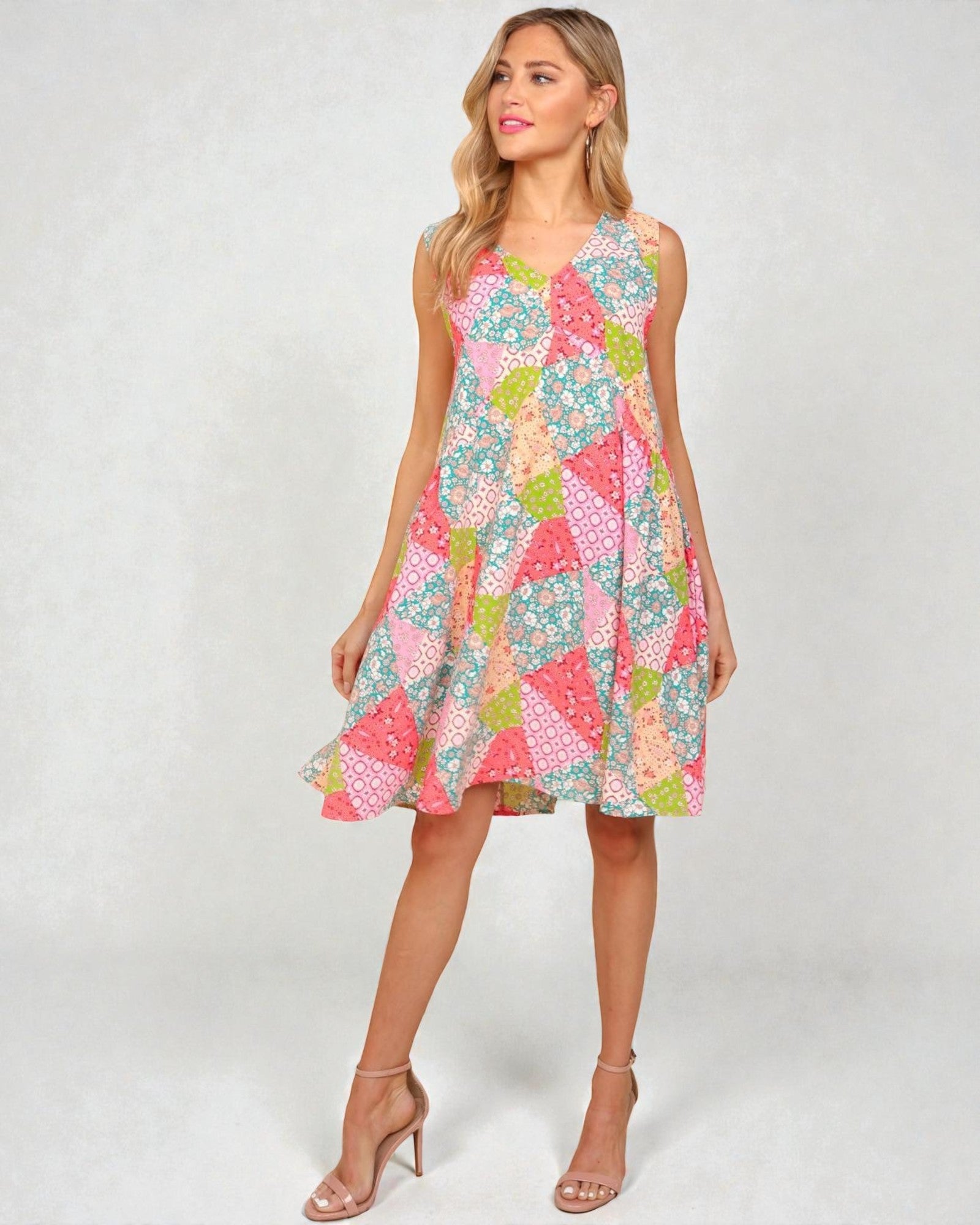 Woman wearing a colorful patterned dress on a white background