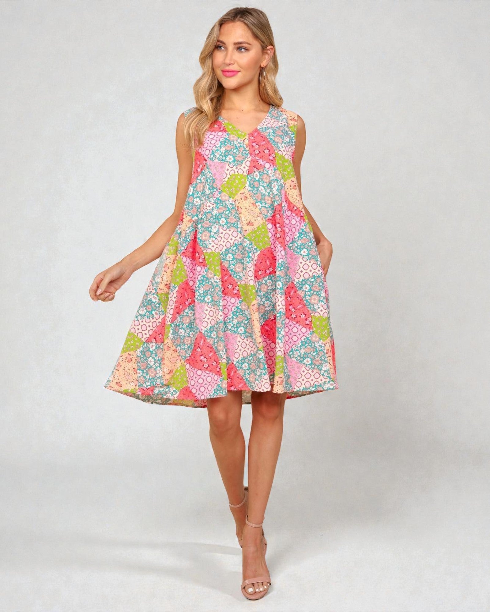 Woman wearing a colorful patterned dress on a white background