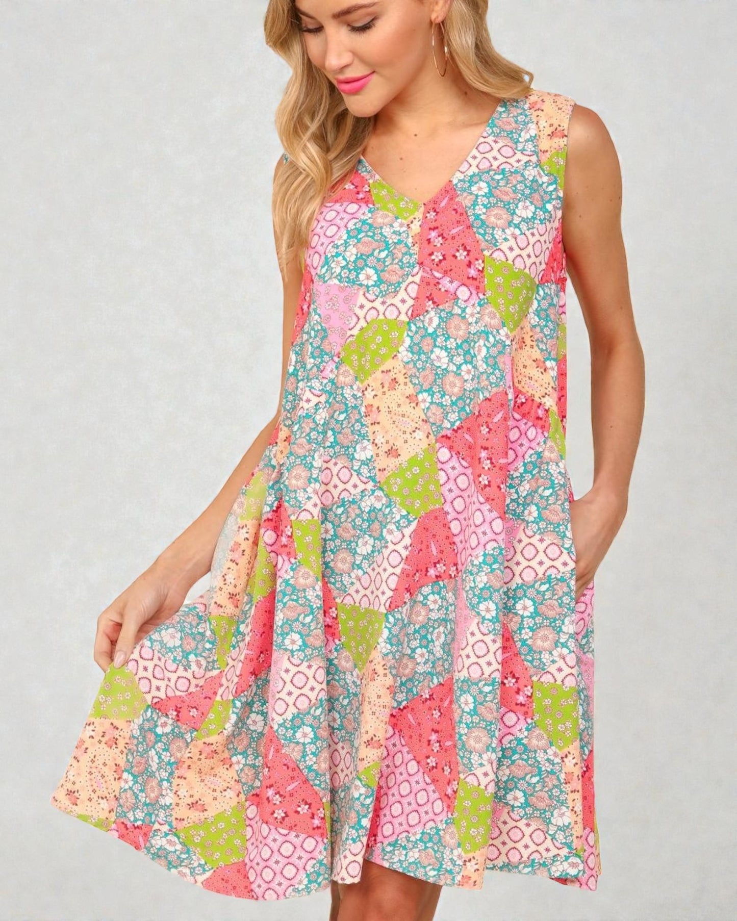 Woman wearing a colorful floral dress on a plain background