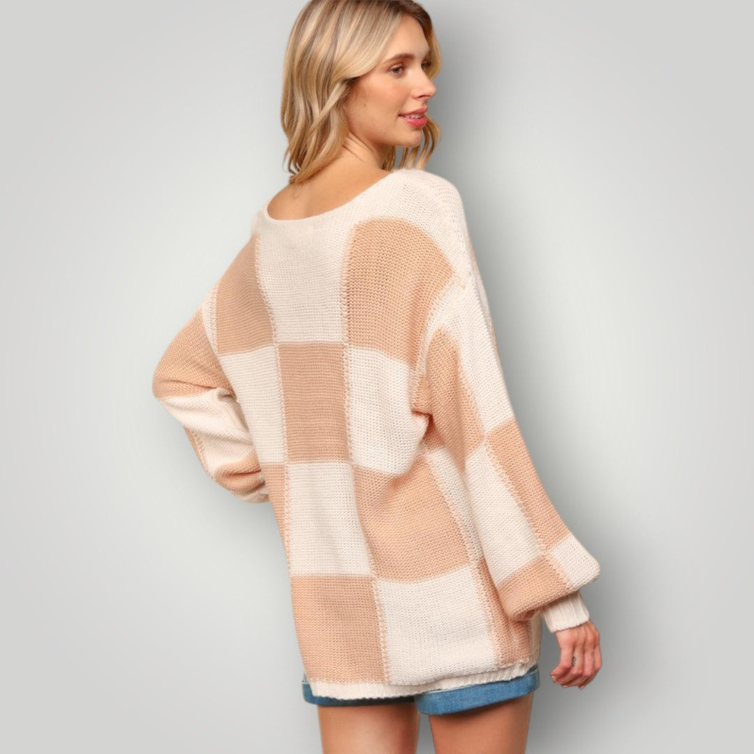 Woman wearing a checkered sweater with a plain background