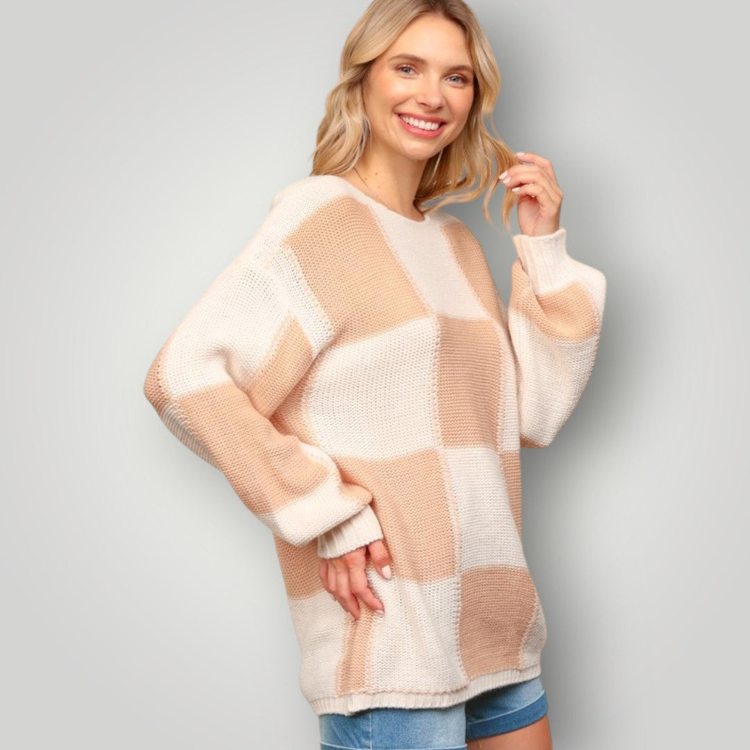 Woman wearing a checkered sweater with a plain background