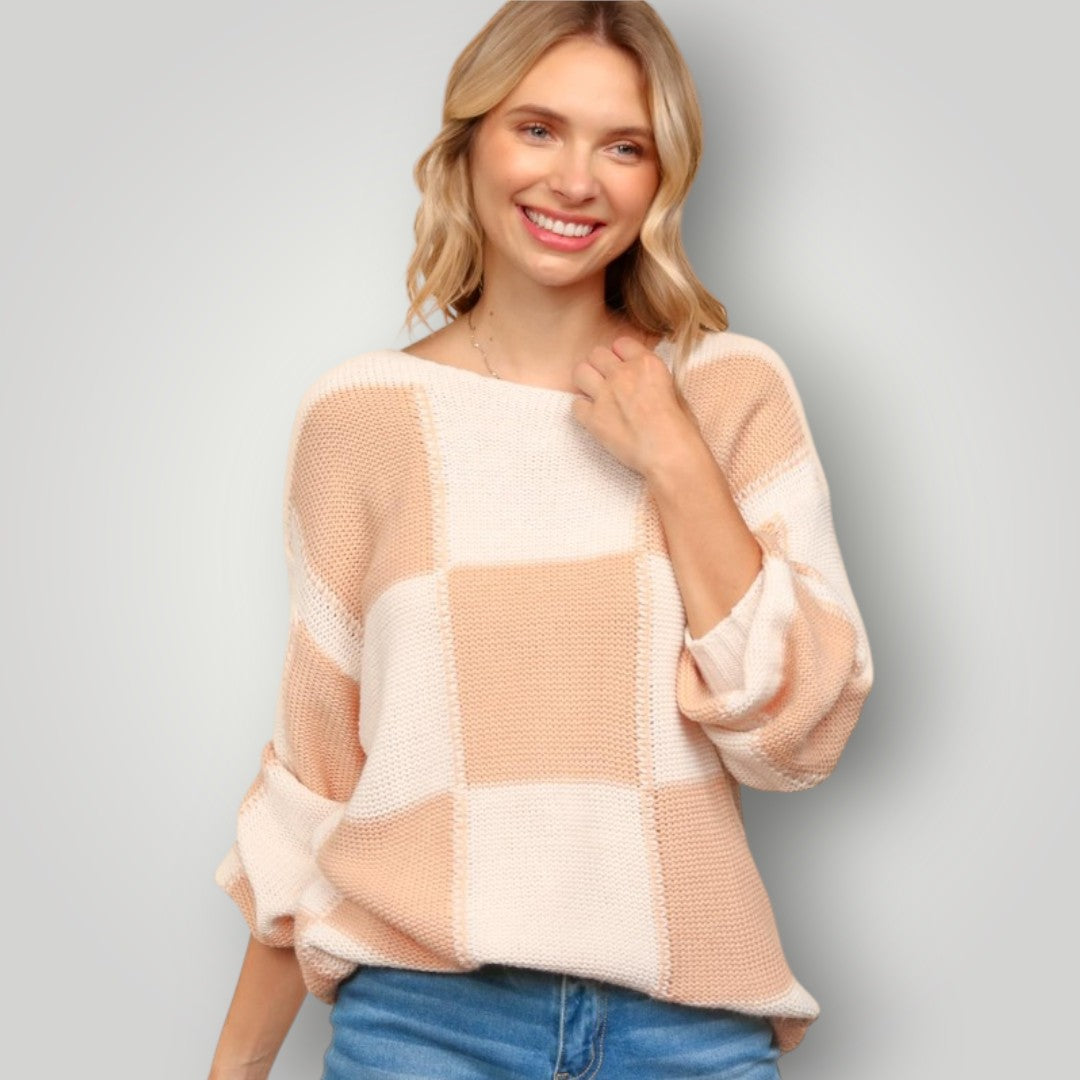 Woman wearing a checkered sweater with a plain background