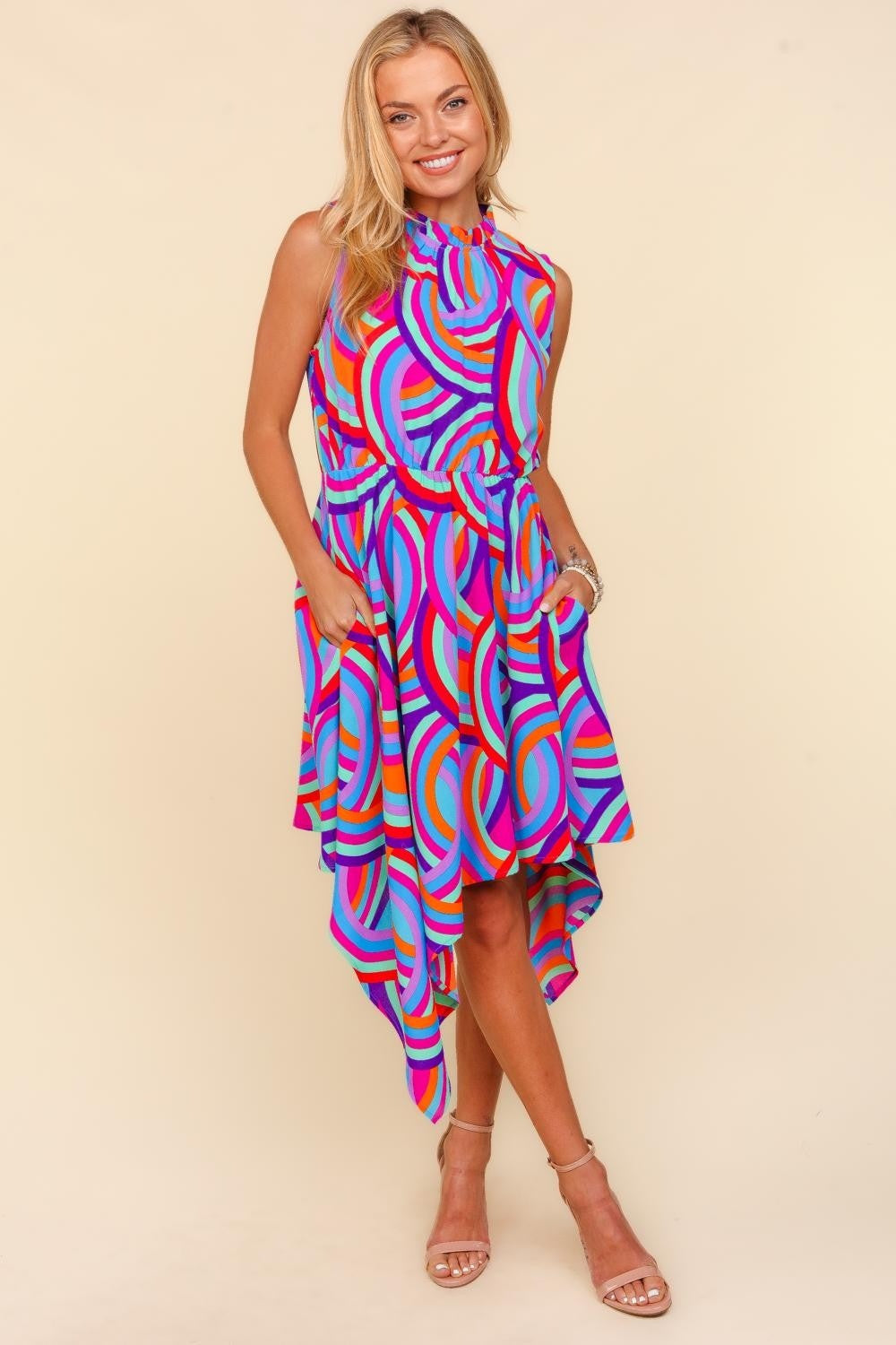 Woman wearing a colorful dress with a pattern on a beige background