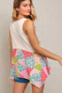 Woman wearing a colorful patchwork skirt with a plain background