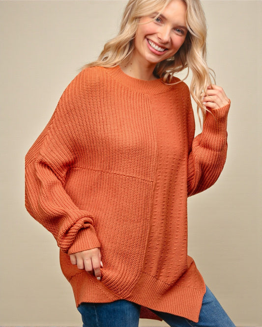 Woman wearing a rust-colored sweater against a beige background