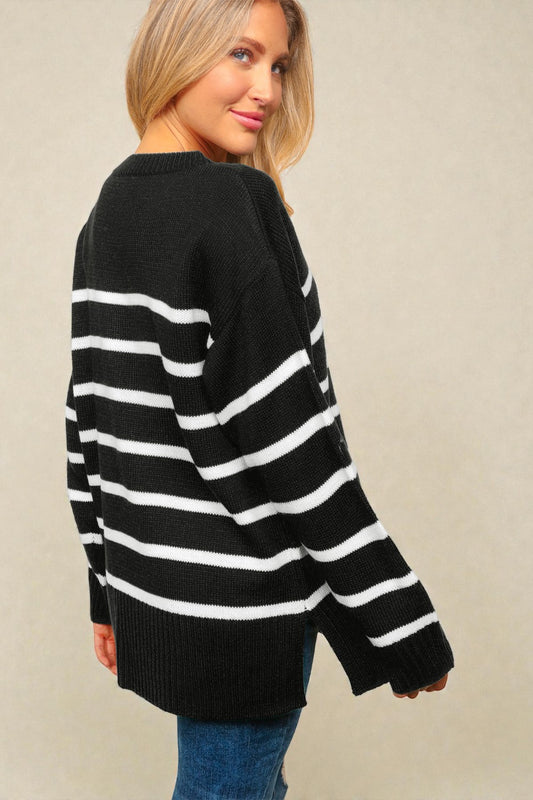 Woman wearing a black and white striped sweater against a beige background
