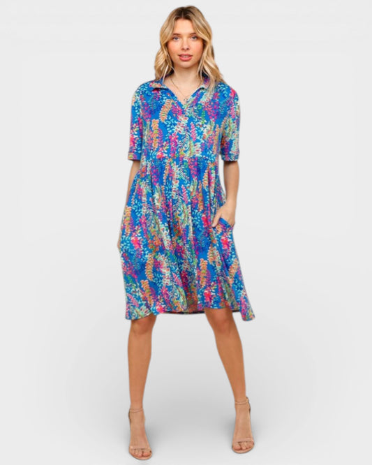 Woman wearing a colorful patterned dress on a white background