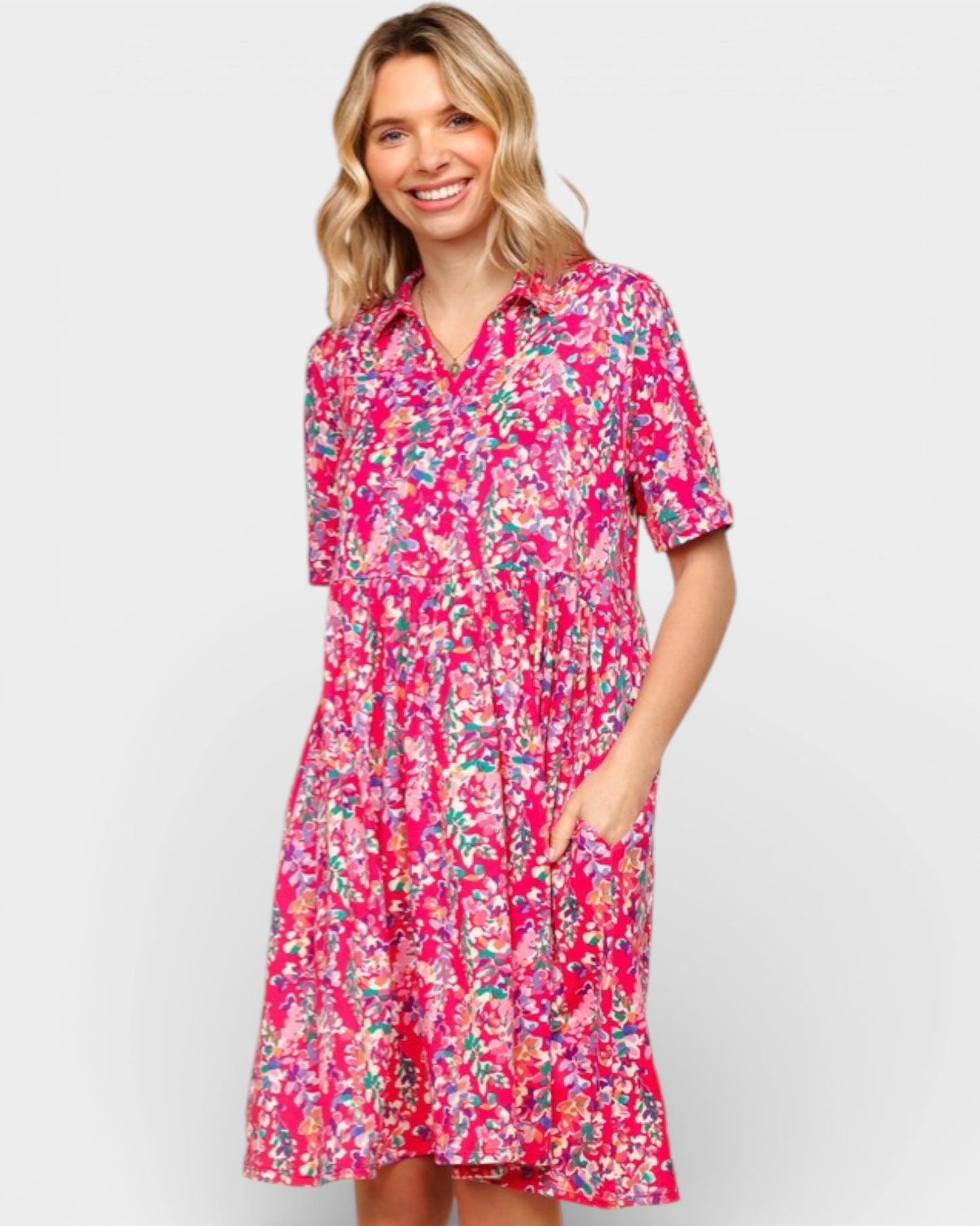 Woman wearing a pink floral dress on a white background