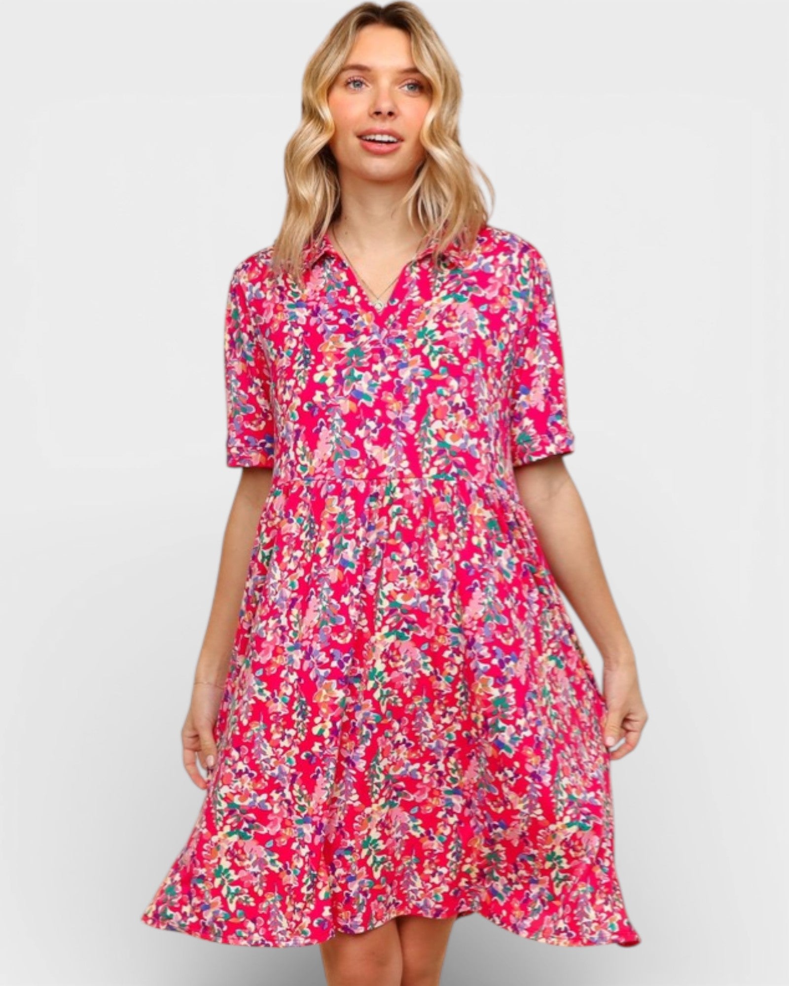 Woman wearing a pink floral dress on a white background