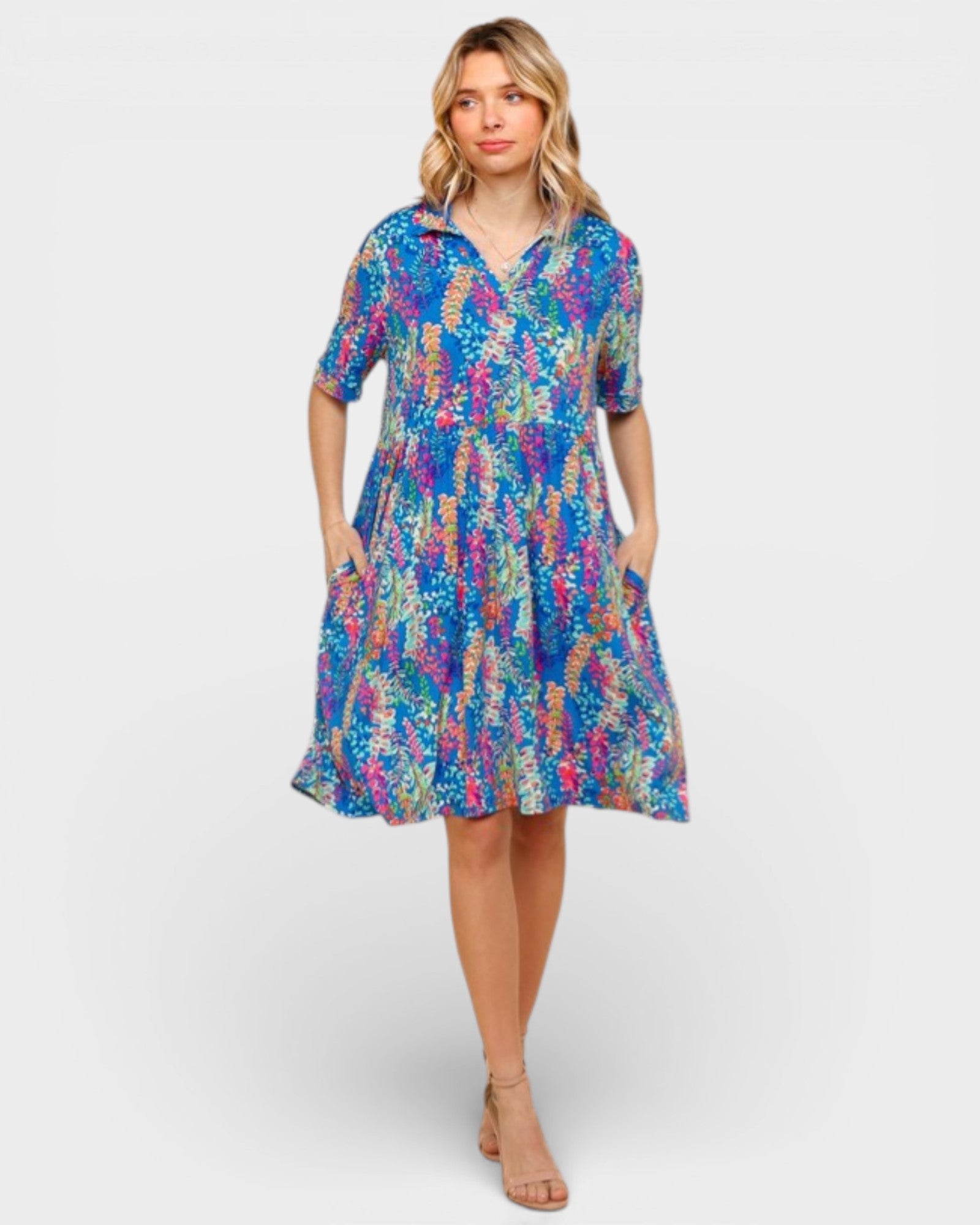 Woman wearing a colorful floral dress on a white background