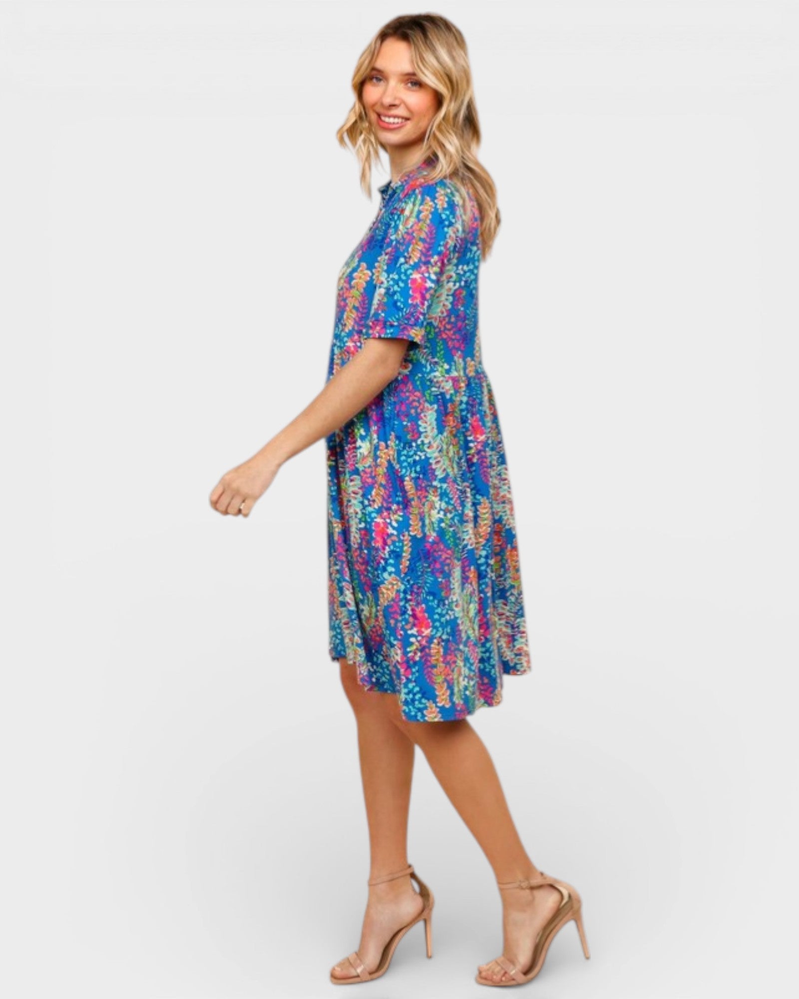 Woman wearing a colorful patterned dress on a white background