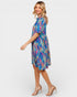 Woman wearing a colorful patterned dress on a white background