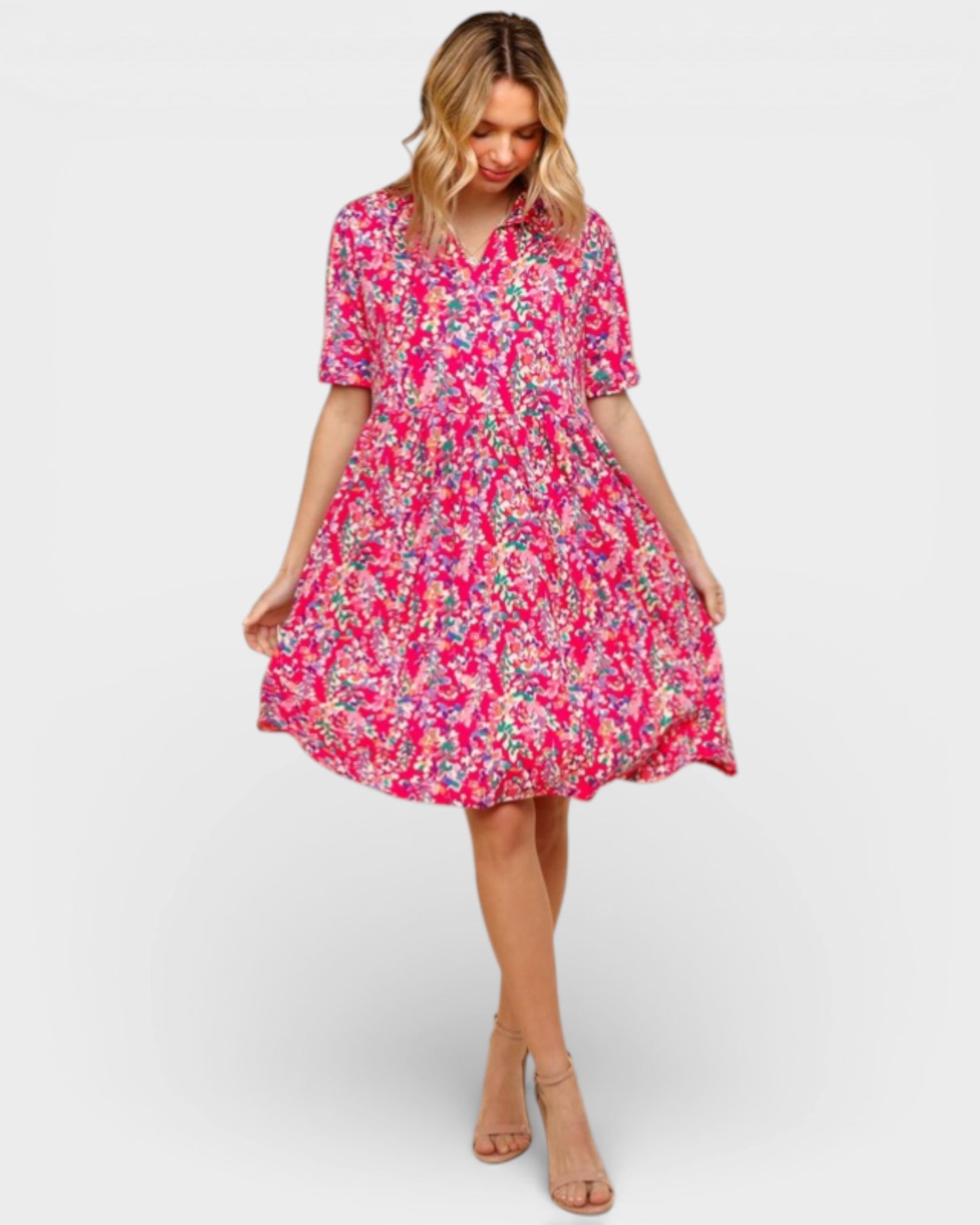 Woman wearing a pink floral dress on a white background
