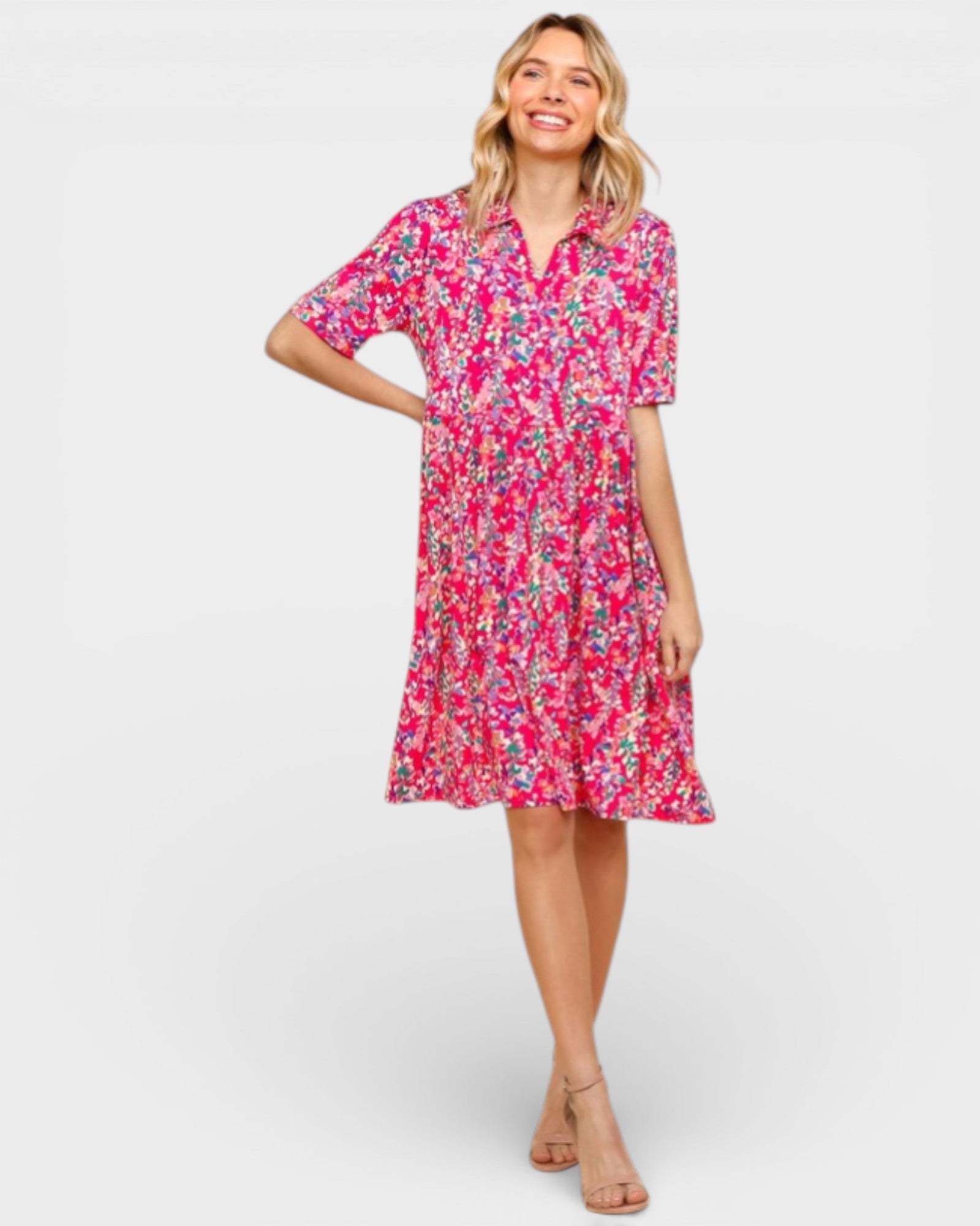 Woman wearing a pink floral dress on a white background