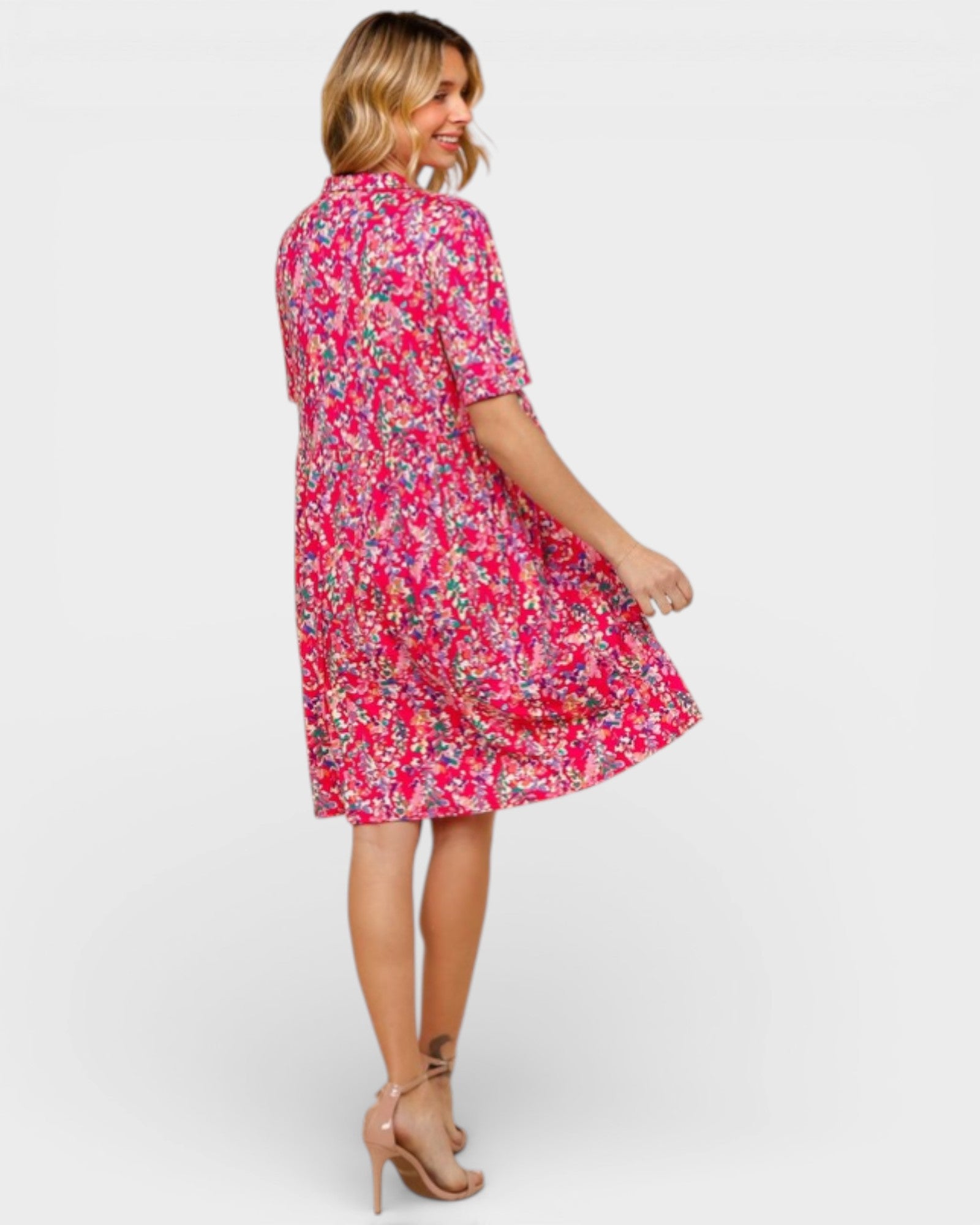 Woman wearing a pink floral dress on a white background
